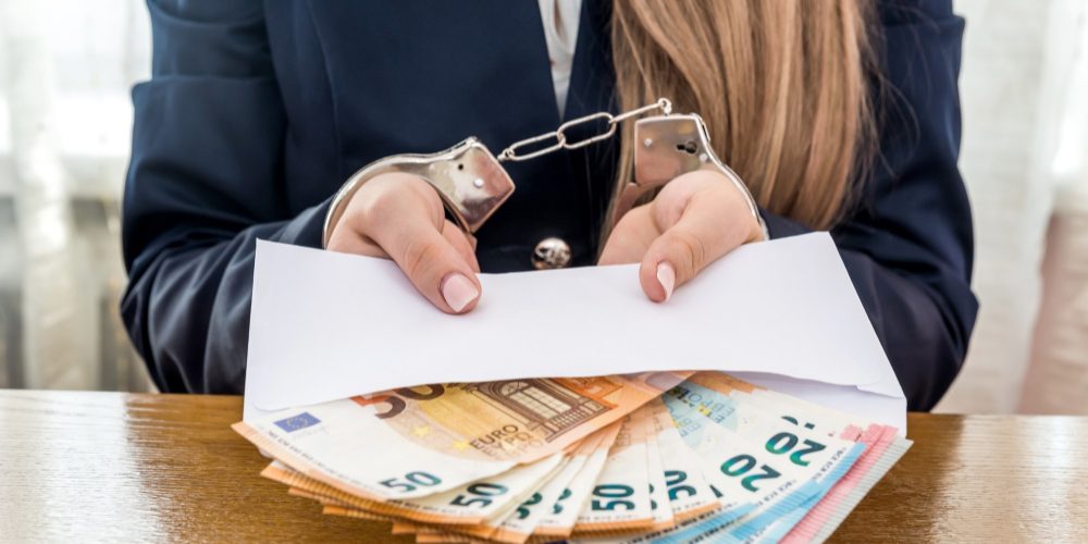 woman-hands-handcuffs-with-euro-notes-envelope